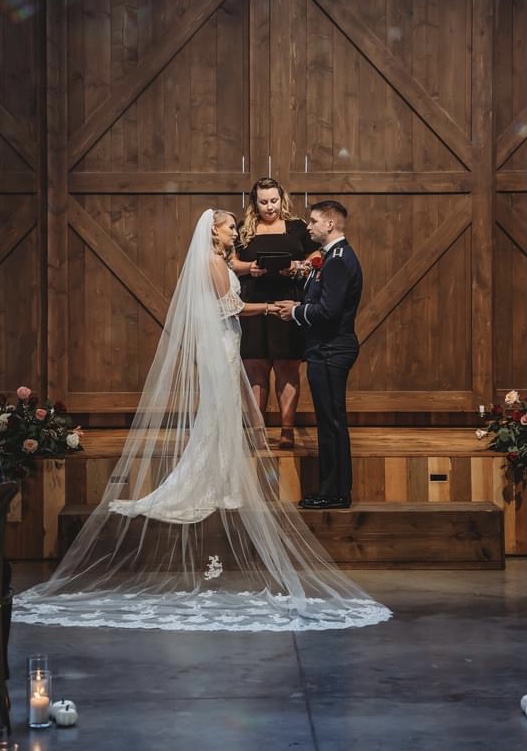 A bride and groom standing next to each other.